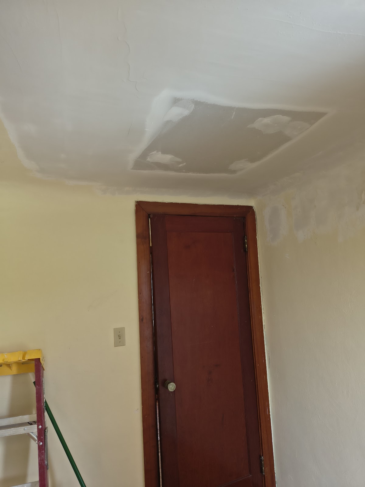 Ceiling patched and skim-coated before finishing
