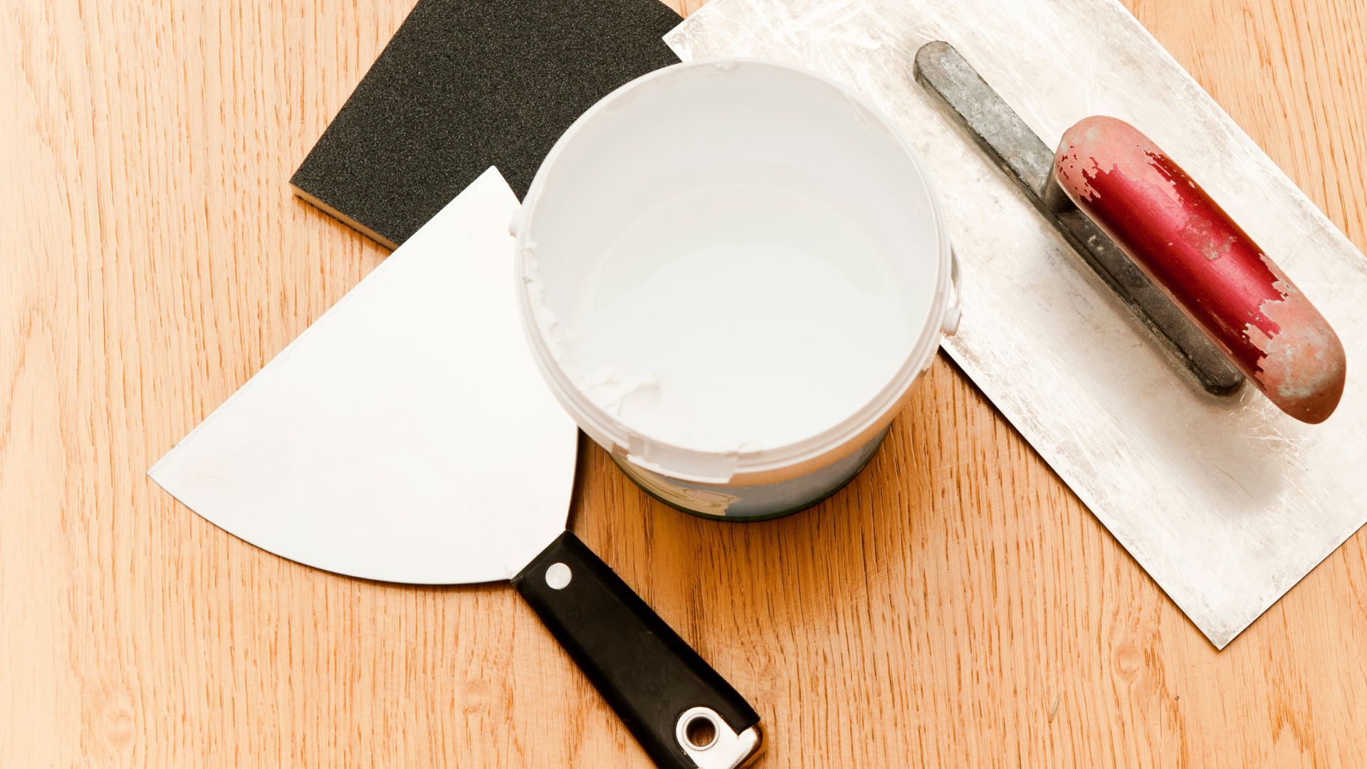 Drywall scraper, joint compound and finishing tools